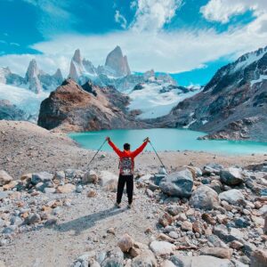 Back View of a Man Standing with His Arms Spread in Laguna de los Tres, Argentina