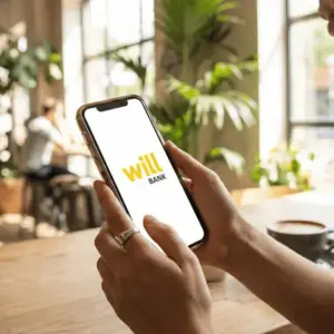 Smartphone exibindo aplicativo do Will Bank bloqueado após decreto de liquidação pelo Banco Central
